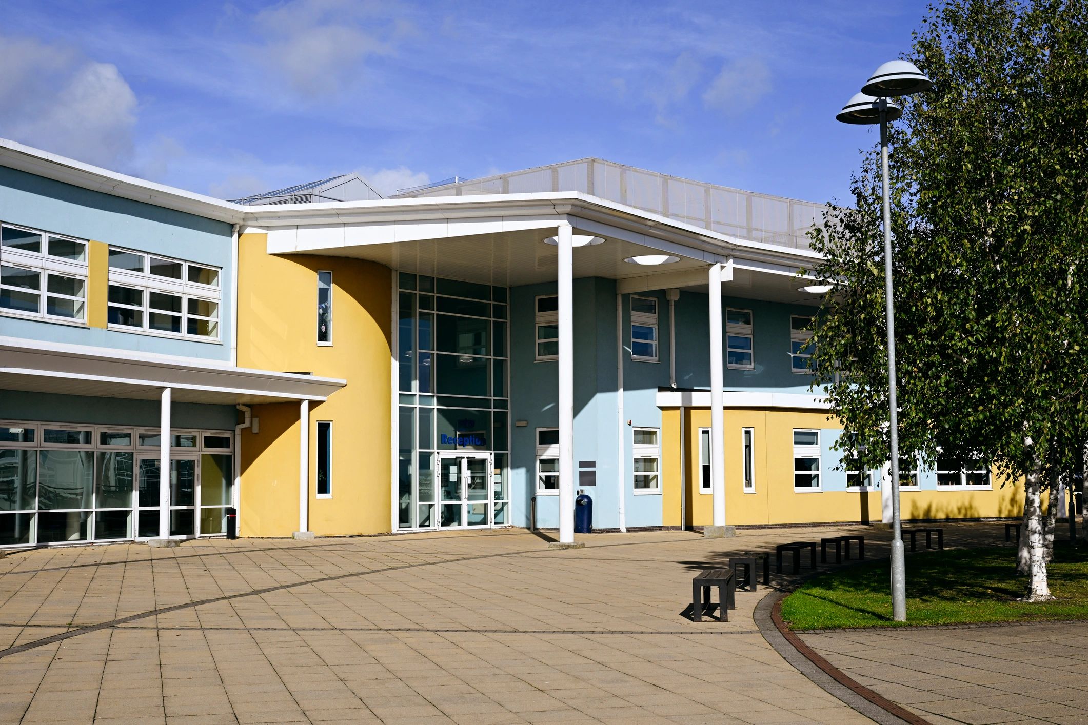 Commercial building exterior featuring large glass storefront systems